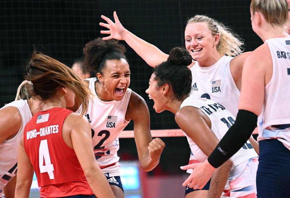 Team USA celebrates a point against China during indoor volleyball.