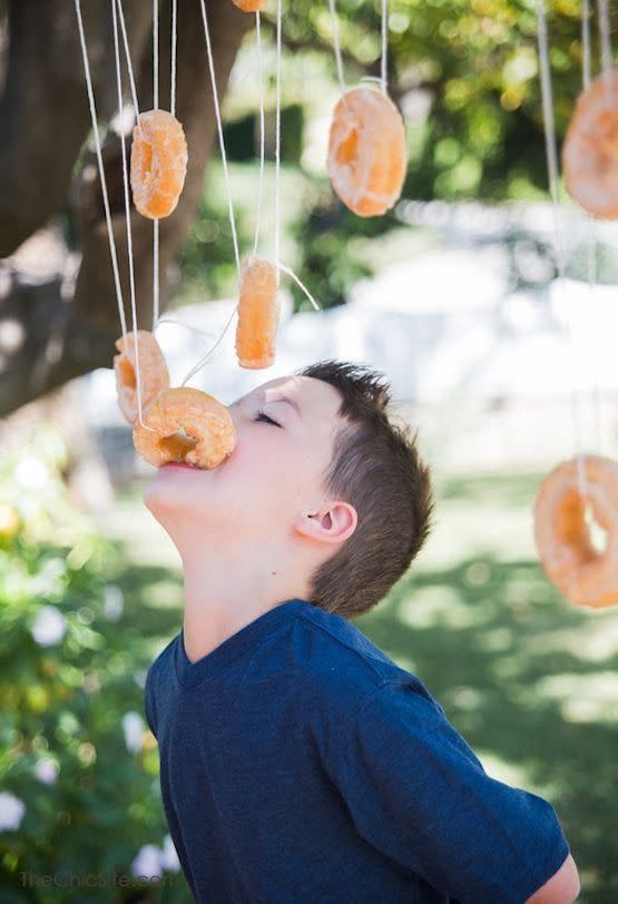 <p>Apple cider donuts are the best treats of the season! String up some donuts from a tree and let kids go after one — it's fun, without the germ-sharing that comes with the more-traditional bobbing for apples game. </p><p><em><a href="http://thechicsite.com/2014/04/17/bobbing-for-donuts/" rel="nofollow noopener" target="_blank" data-ylk="slk:Get the tutorial at The Chic »;elm:context_link;itc:0;sec:content-canvas" class="link ">Get the tutorial at The Chic »</a></em> </p>