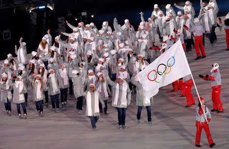 Pyeongchang 2018 Winter Olympics – Opening ceremony – Pyeongchang Olympic Stadium - Pyeongchang, South Korea – February 9, 2018 - A volunteer carries the flag of the Olympic Athletes from Russia. REUTERS/Eric Gaillard