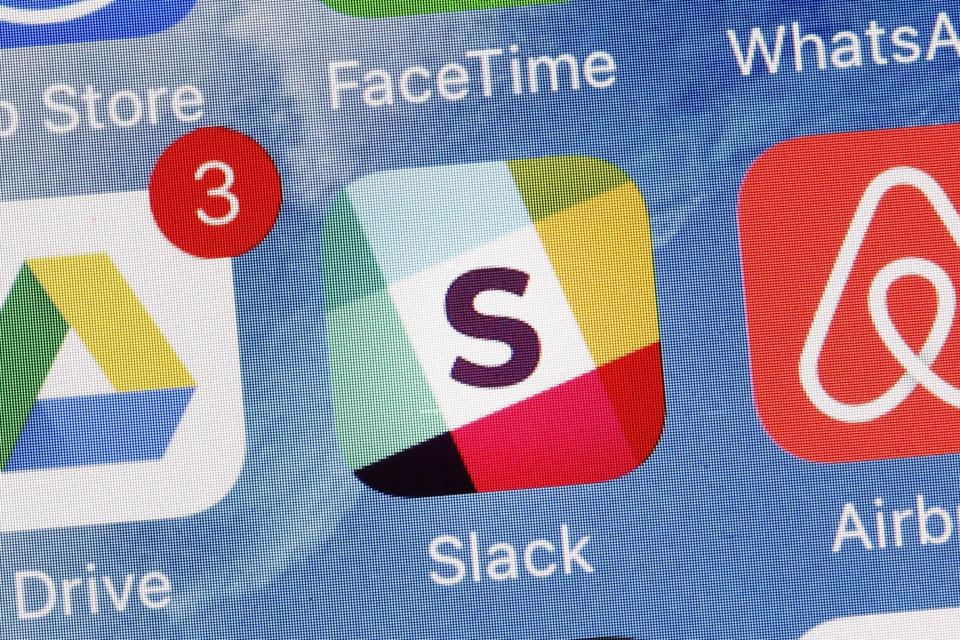 The Slack app is displayed on a mobile phone, Tuesday, Jan. 31, 2017, in New York. Slack Technologies is hoping to convert more big businesses to its online business messaging service by making it easier for workers in different departments to communicate with each other. The new option, called "Enterprise Grid," represents another major step in Slack's attempt to get more workers and employers to lessen their dependence on conventional email and embrace its service instead. (AP Photo/Mark Lennihan)