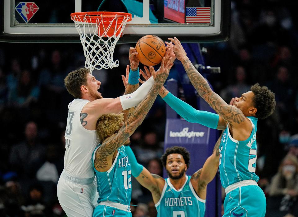 Thunder center Mike Muscala, left, vies for a rebound with Hornets guard Kelly Oubre Jr. (12) and forward P.J. Washington, right, as Hornets forward Miles Bridges watches during the first half Friday in Charlotte, N.C.