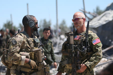 U.S. forces are seen at the Kurdish People's Protection Units (YPG) headquarters after it was hit by Turkish airstrikes in Mount Karachok near Malikiya, Syria April 25, 2017. REUTERS/ Rodi Said