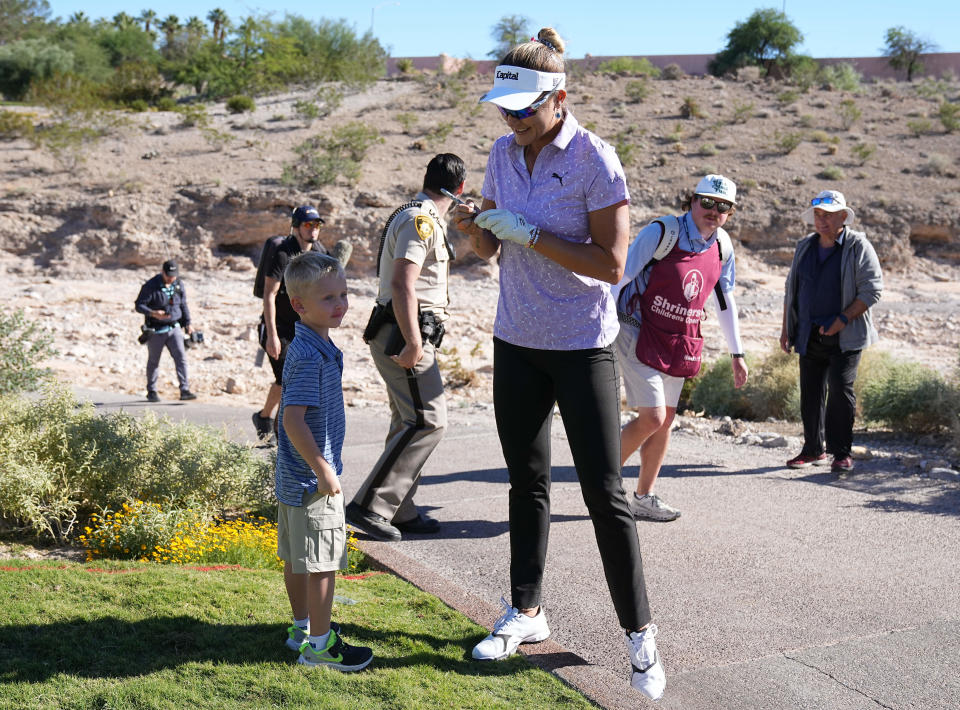 Lexi Thompson signs a golf ball for a young fan during the first round of the Shriners Children’s Open golf tournament at TPC Summerlin. Mandatory Credit: Ray Acevedo-USA TODAY Sports
