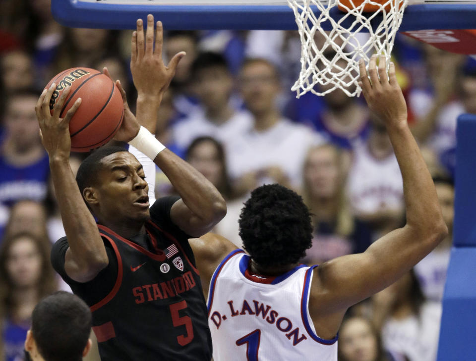 Stanford forward Kodye Pugh (5) rebounds against Kansas forward Dedric Lawson (1) during the first half of an NCAA college basketball game in Lawrence, Kan., Saturday, Dec. 1, 2018. (AP Photo/Orlin Wagner)