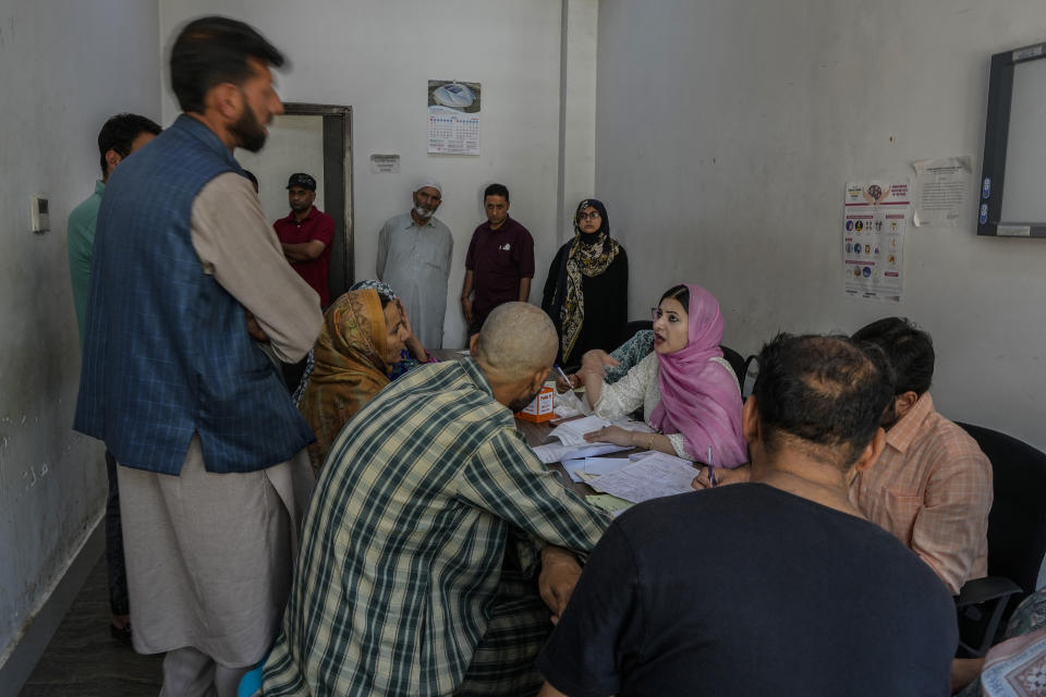 Dr. Alia and other doctors attend to patients inside the outpatient department (OPD) at a mental health hospital in Srinagar, Indian controlled Kashmir, Tuesday, Aug 1, 2023. Kashmir's mental healthcare clinics depict invisible scars of decades of violent armed insurrections, brutal counterinsurgency, unparalleled militarization, unfulfilled demands for self-determination have fueled depression and drugs in the disputed region, experts say. (AP Photo/Mukhtar Khan)