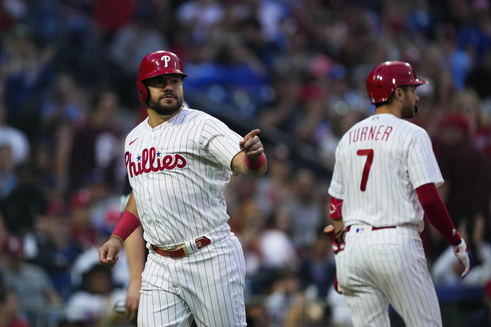 Philadelphia Phillies' Kyle Schwarber pointsafter scoring on a hit by Bryce Harper during the third inning of the team's baseball game against the Los Angeles Dodgers, Friday, June 9, 2023, in Philadelphia. (AP Photo/Matt Rourke)