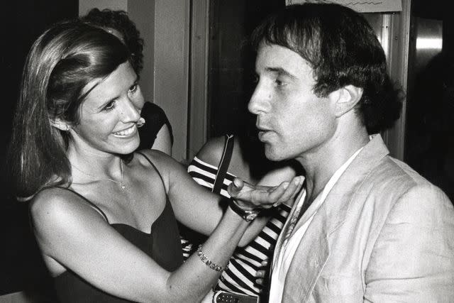 <p>Ron Galella Collection via Getty</p> Carrie Fisher and Paul Simon in New York City in August 1980