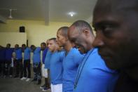 Prisoners attend a prayer session inside the new wing of the Najayo prison in San Cristobal, May 1, 2014. Ten years after the country opened its first prison designed with a focus on education and clean living conditions and staffed by graduates from a newly created academy for penitentiary studies, the New Model of Prison Management is gaining recognition from other countries in the region trying to reduce prison populations and cut recidivism rates. Picture taken May 1, 2014. REUTERS/Ricardo Rojas (DOMINICAN REPUBLIC - Tags: CRIME LAW POLITICS SOCIETY)