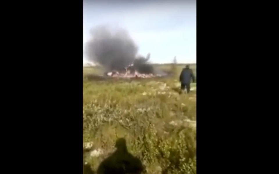 In this image made from a Russian Emergency Situations Ministry video, a smoke rises from a crash side of a Russian helicopter Mi-8 crashed shortly after takeoff in Vankor, above the Arctic Circle in Siberia, Russia, Saturday, Aug. 4, 2018. A Russian helicopter crashed shortly after takeoff in Siberia on Saturday, killing all 18 people aboard. The Interstate Aviation Committee, which oversees civil aviation in much of the former Soviet Union, said the Mi-8 helicopter collided with the load being carried by another helicopter that had taken off from the same pad in Vankor, above the Arctic Circle about 2,600 kilometers (1600 miles) northeast of Moscow. The second helicopter was undamaged and landed safely, the committee said. (Russian Ministry for Emergency Situations photo via AP)