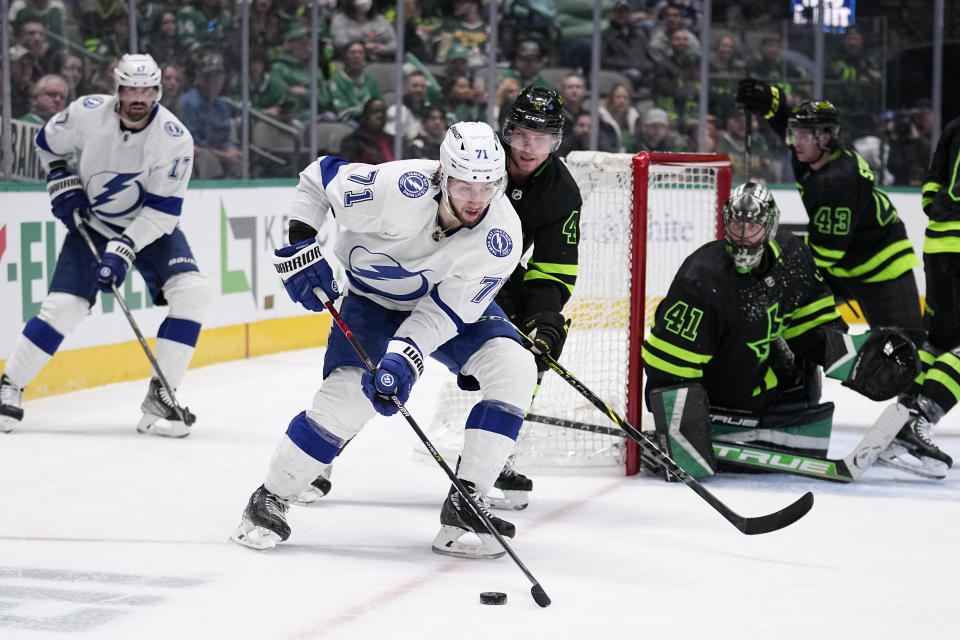 Tampa Bay Lightning center Anthony Cirelli (71) attempts to make a pass to the front of the net as Dallas Stars' Miro Heiskanen (4) and goalie Scott Wedgewood (41) defend in the second period of an NHL hockey game, Saturday, Feb. 11, 2023, in Dallas. (AP Photo/Tony Gutierrez)