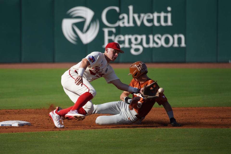 May 31, 2024; College Station, TX, USA; Texas Longhorns infielder Jared Thomas (9) makes it safe to second base against Louisiana Ragin Cajuns infielder John Taylor (10) during the first round in the NCAA baseball College Station Regional at Olsen Field. Mandatory Credit: Dustin Safranek-USA TODAY Sports