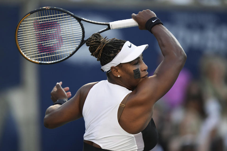 Serena Williams, of the United States, follows through on a return to Belinda Bencic, of Switzerland, during the National Bank Open tennis tournament Wednesday, Aug. 10, 2022, in Toronto. (Nathan Denette/The Canadian Press via AP)