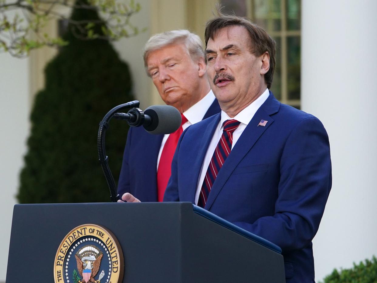 US President Donald Trump listens as Michael J. Lindell, CEO of MyPillow Inc., speaks during the daily briefing on the novel coronavirus, Covid-19, in the Rose Garden of the White House in Washington, DC, on 30 March 2020 ((AFP via Getty Images))