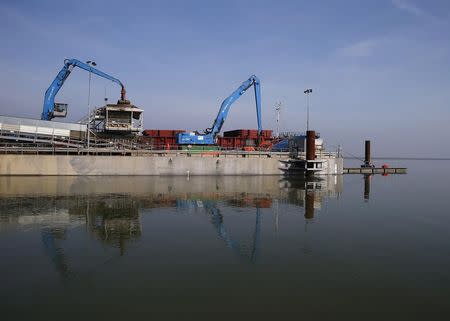 Machinery is used to unload a ship carrying earth from the Crossrail project which will be used to landscape a saltwater marsh wildlife habitat on Wallasea island, in Essex, March 13, 2014. REUTERS/Andrew Winning