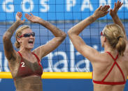 U.S.' Heather Hughes, left, celebrates with teammate Emily Day after defeating Chile in a women's beach volleyball match at the Pan American Games in Puerto Vallarta, Mexico, Sunday Oct. 16, 2011. (AP Photo/Ariana Cubillos)