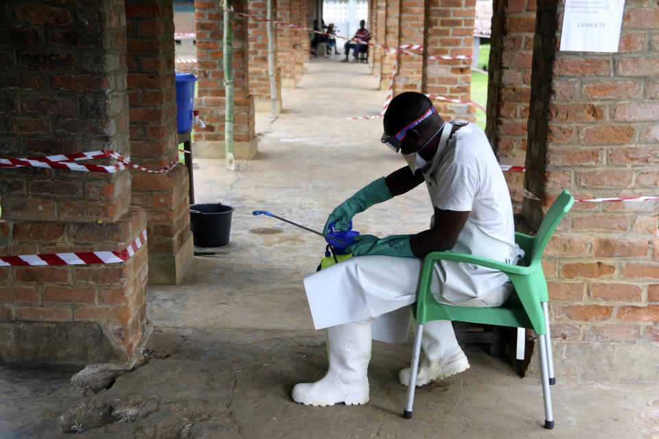 FILE - In this May 13, 2018 file photo shot by AP contributing photographer John Bompengo, a health care worker wears protective gear at an Ebola treatment center in Bikoro, Democratic Republic of Congo. Relatives say longtime Associated Press contributor John Bompengo has died of COVID-19 in Congo's capital. Bompengo, who had covered his country's political turmoil over the course of 16 years, died Saturday, June 20, 2020 at a Kinshasa hospital. (AP Photo/John Bompengo, file)