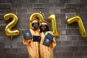 Lydia (left) and Joy show off their diplomas.