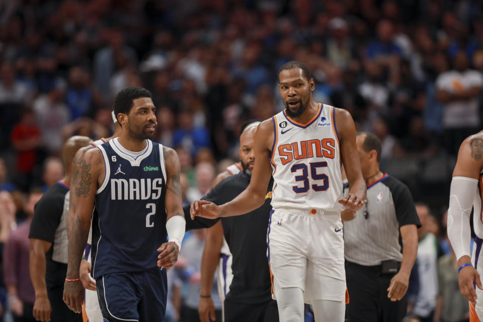 Dallas Mavericks guard Kyrie Irving (2) and Phoenix Suns forward Kevin Durant (35) walk down the court during the second half of an NBA basketball game, Sunday, March 5, 2023, in Dallas. (AP Photo/Gareth Patterson)