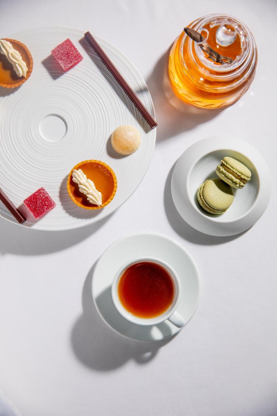 An overhead photo of cookies, a cup of tea and delicate chocolate bars at a restaurant.