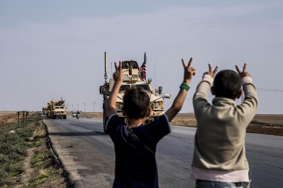 U.S. military convoy drives near the town of Qamishli, north Syria, Saturday, Oct. 26. 2019. A U.S. convoy of over a dozen vehicles was spotted driving south of the northeastern city of Qamishli, likely heading to the oil-rich Deir el-Zour area where there are oil fields, or possibly to another base nearby. The Syrian Observatory for Human Rights, a war monitor, also reported the convoy, saying it arrived earlier from Iraq. (AP Photo/Baderkhan Ahmad)