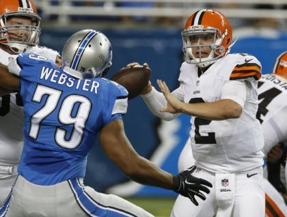 Johnny Manziel (2) is pressured by Lions DE Larry Webster in the second half of Saturday's game. (AP)