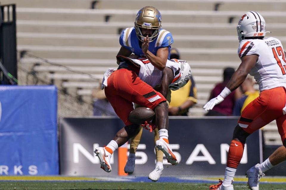 Bowling Green's PaSean Wimberly blocks a kick by UCLA place kicker Nicholas Barr-Mira.