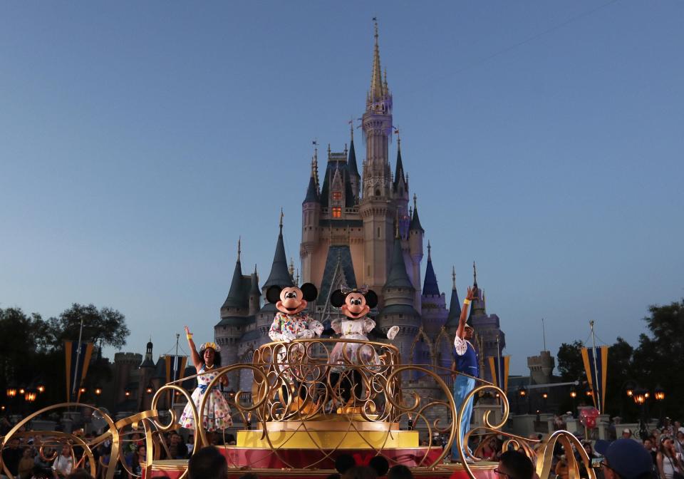 Mickey and Minnie Mouse shown performing during a parade as they pass by the Cinderella Castle at the Magic Kingdom theme park at Walt Disney World in Lake Buena Vista. State lawmakers and Gov. Ron DeSantis have punished the park for objecting to the governor&#39;s parental rights protections derided and better known as the  &quot;Don&#39;t Say Gay&quot; law.