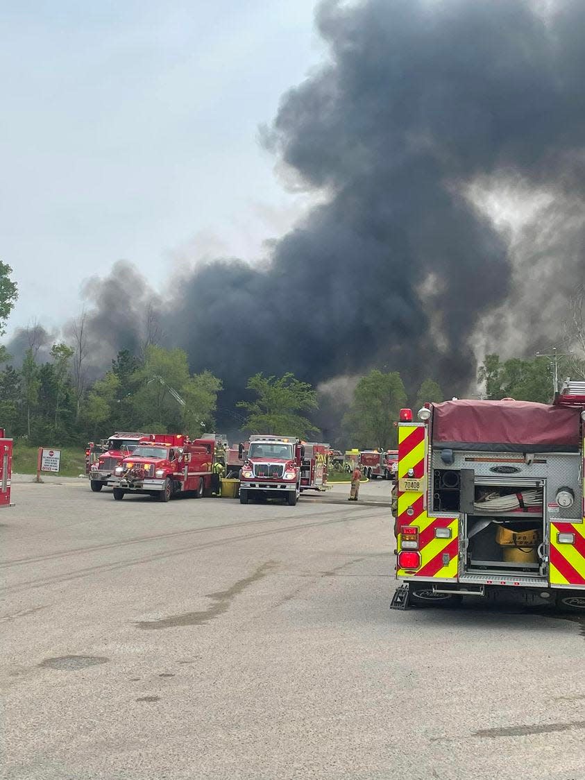 Fire crews battle a blaze at a recycling center May 24, 2023 near Pardeeville, Wis.