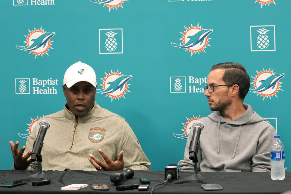 Miami Dolphins general manager Chris Grier, left, and head coach Mike McDaniel, right, respond to questions during a news conference at the NFL football team's training facility, Monday, Jan. 16, 2023, in Miami Gardens, Fla. (AP Photo/Lynne Sladky)