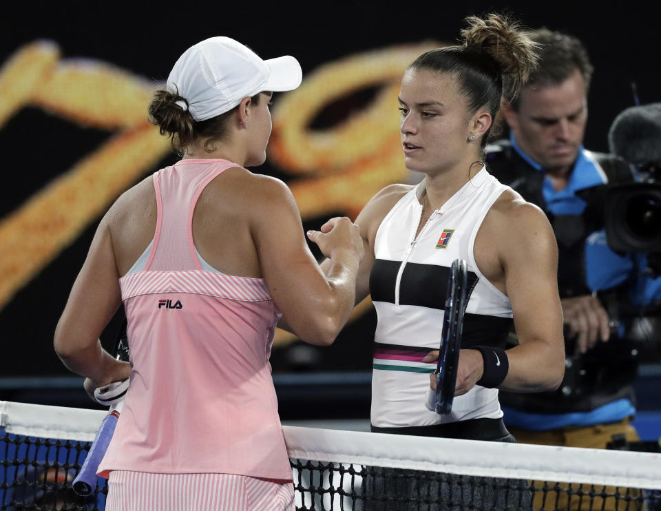 Australia's Ashleigh Barty, left, is congratulated by Greece's Maria Sakkari after winning their third round match at the Australian Open tennis championships in Melbourne, Australia, Friday, Jan. 18, 2019. (AP Photo/Kin Cheung)