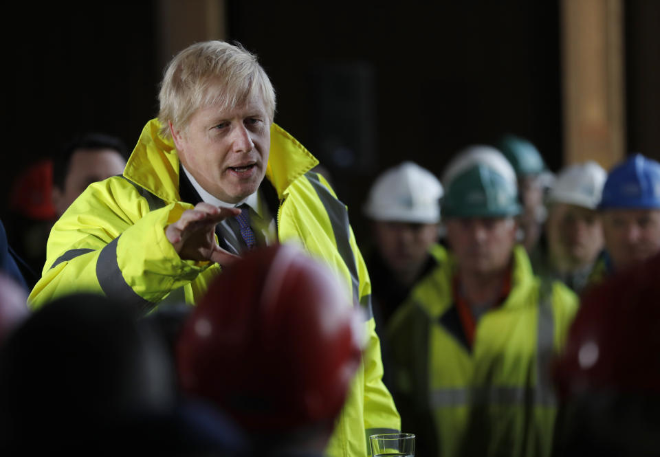 Britain's Prime Minister Boris Johnson speaks to workers during a visit to Wilton Engineering Services, part of a General Election campaign trail stop in Middlesbrough, England, Wednesday, Nov. 20, 2019. Britain goes to the polls on Dec. 12. (AP Photo/Frank Augstein, Pool)