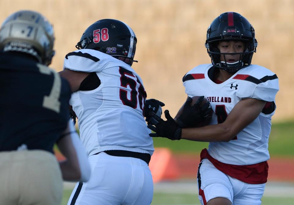 Levelland's Jayden Flores, right, runs with the ball against Levelland, Thursday, Sept. 8, 2022, at Lowrey Field at PlainsCaptial Park. Lubbock High won, 21-14.