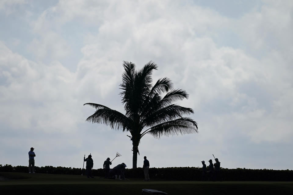 Workers groom the course after heavy thunderstorms moved through yesterday, on a practice day for the Walker Cup golf tournament at Seminole Golf Club in Juno Beach, Fla., Friday, May 7, 2021. (AP Photo/Gerald Herbert)