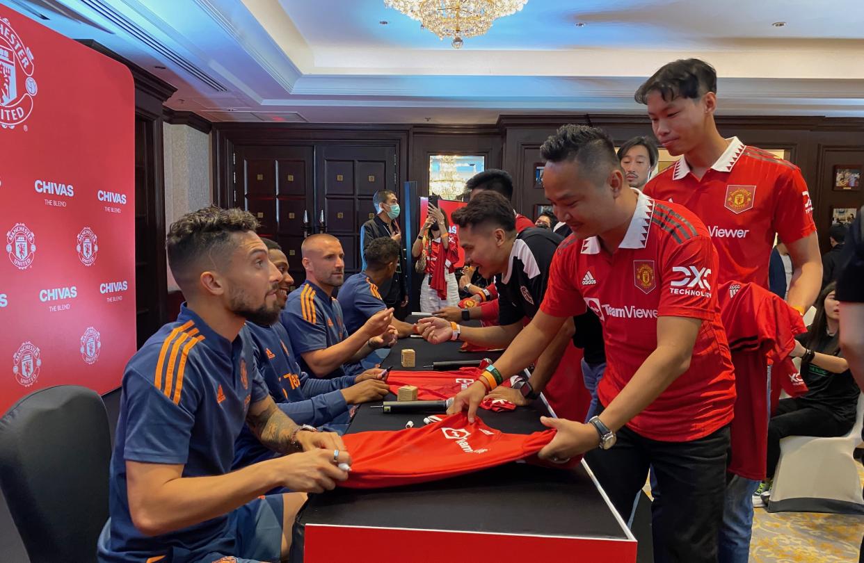 Manchester United players (from left) Alex Telles, Anthony Martial, Luke Shaw and Raphael Varane sign autographs for Thai fans during a meet-and-greet fan session organised by Chivas Regal. (PHOTO: Chia Han Keong/Yahoo News Singapore)