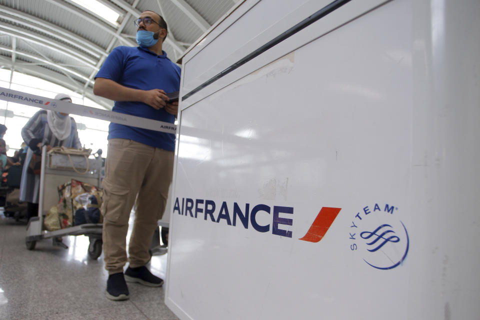 A traveler queues at the Houari Boumediene airport for a flight bound to Paris, Tuesday, June 1, 2021 in Algiers. Algeria has partially reopened its air borders Tuesday for the first time in over 15 months of the COVID-19 crisis. (AP Photo/Fateh Guidoum)