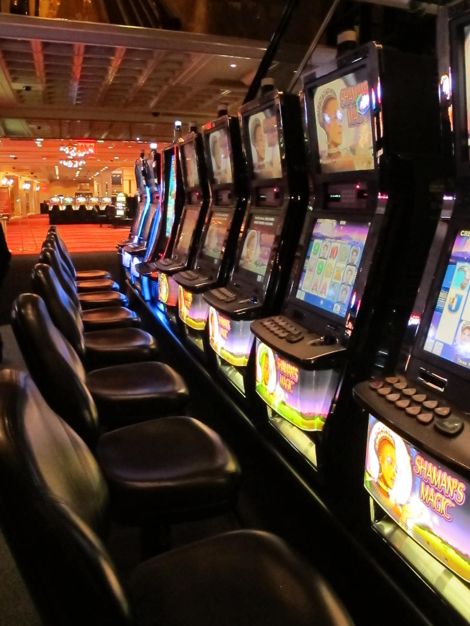 A row of slot machines sit late Sunday, Jan. 12, 2014, at the mostly empty Atlantic Club Casino Hotel in the moments before the casino shut down, in Atlantic City, N.J. The casino ceased operations at 12:01 am on Monday. Jan. 13. (AP Photo/Wayne Parry)