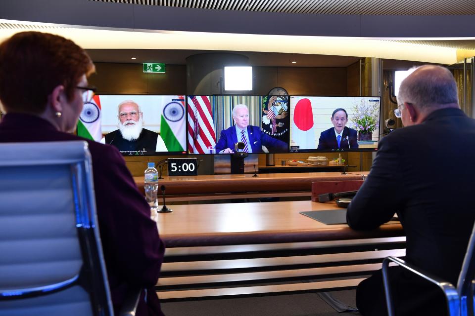 Australia's Prime Minister Scott Morrison, right, and Minister for Foreign Affairs Marise Payne, left, participate in the inaugural Quad leaders meeting with the President of the United States Joe Biden, the Prime Minister of Japan Yoshihide Suga and the Prime Minister of India Narendra Modi in a virtual meeting in Sydney, Saturday, March 13, 2021. Morrison said his first-ever meeting with President Joe Biden as well as the leaders of India and Japan will become an anchor of stability in the Indo-Pacific region.