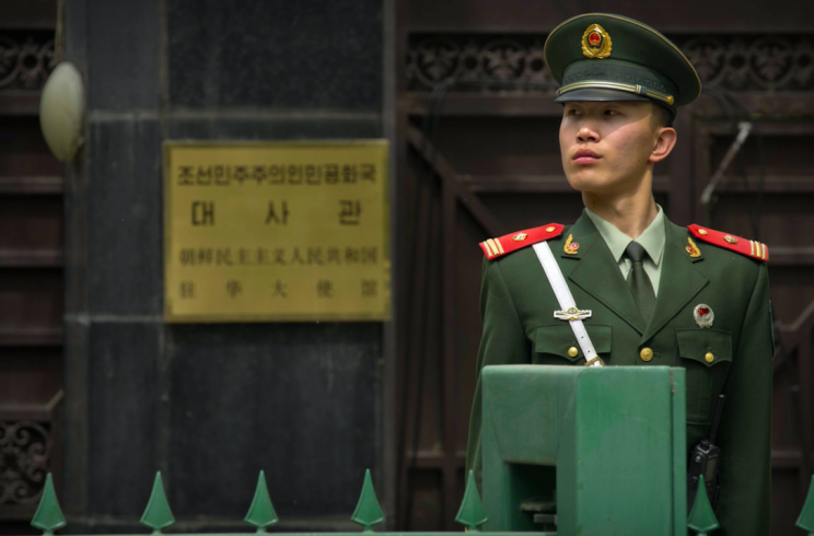 A Chinese policeman stands guard outside the North Korean Embassy in Beijing (Picture: Rex)