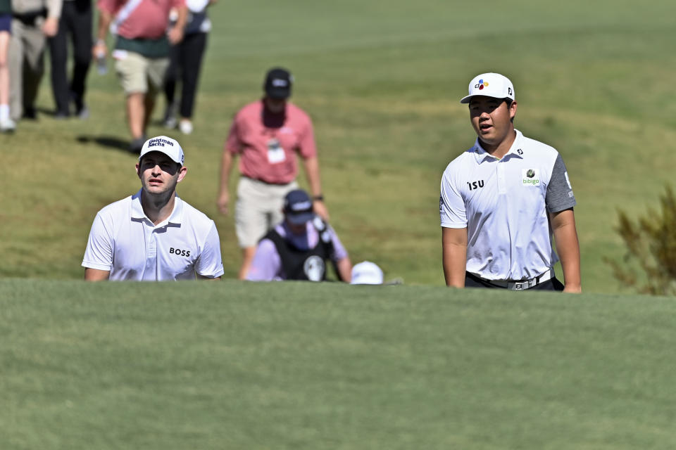 Patrick Cantlay, left, and Tom Kim, of South Korea, approach the third green during the final round of the Shriners Children's Open golf tournament, Sunday, Oct. 9, 2022, in Las Vegas. (AP Photo/David Becker)