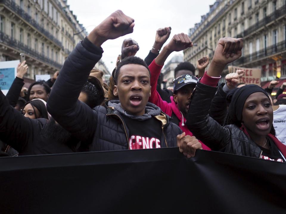 People gesture as they protest against police violence, in Paris, Sunday, March 19, 2017. Protesters carried placards and banners as they gathered at Place de la Republique, a square in the centre of the French capital, to listen to speeches. (AP Photo/Thibault Camus)