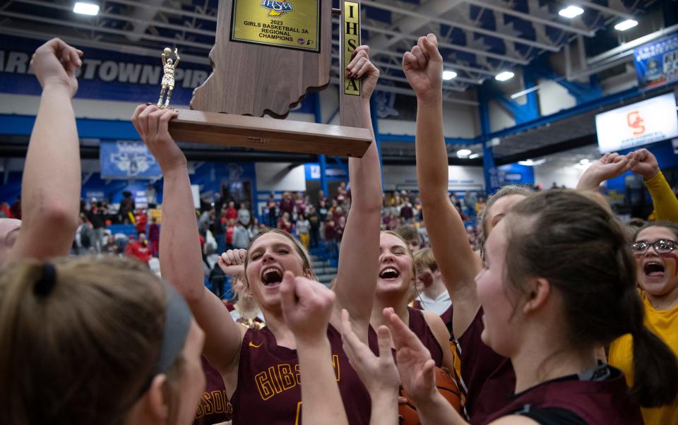 Gibson Southern's Alexis Tucker (4) holds the regional championship trophy aloft after their Class 3A regional against Princeton at Charlestown High School Saturday night, Feb. 11, 2023. Gibson Southern beat Princeton 71-55 to advance to semi-state next Saturday, Feb. 18, 2023.