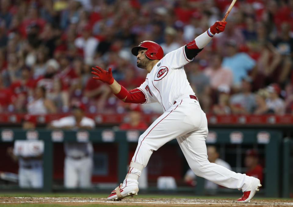 Cincinnati Reds' Eugenio Suarez (7) watches the flight of a two-run home run off Milwaukee Brewers starting pitcher Adrian Houser during the sixth inning of a baseball game, Monday, July 1, 2019, in Cincinnati. (AP Photo/Gary Landers)