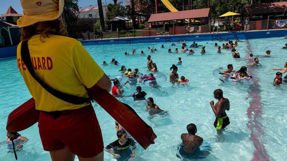 A lifeguard watches visitors swim at the Raging Waters Sacramento water park at Cal Expo in Sacramento, California. There's a shortage of guards this year, so be extra vigilant. - David Paul Morris/Bloomberg/Getty Images