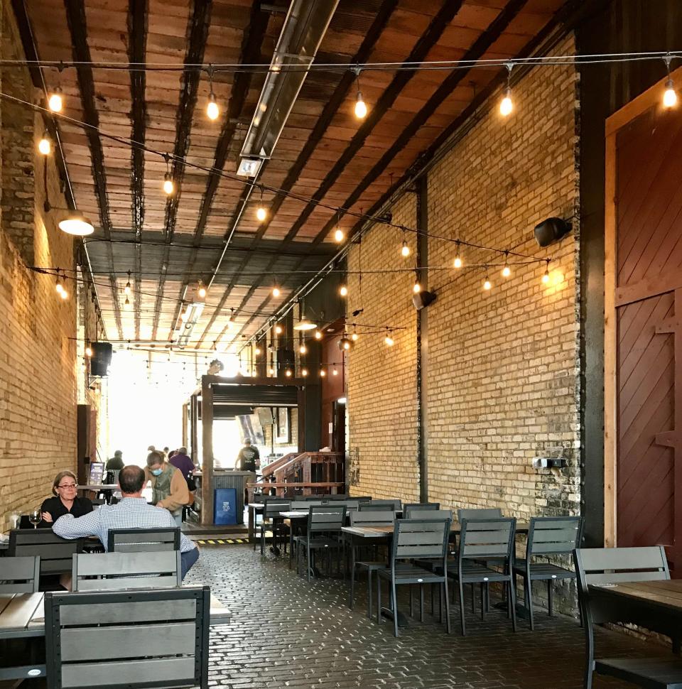 The main patio for the Explorium Brewpub in downtown Milwaukee is in an open-ended tunnel lined with Cream City bricks in the Pritzlaff building.