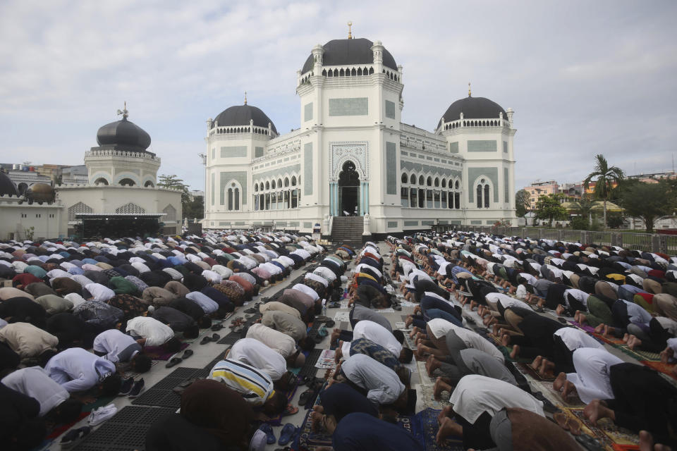 Muslims perform a morning prayer marking the Eid al-Adha holiday in front of Al Mashun Great Mosque in Medan, Indonesia, Thursday, June 29, 2023. Muslims around the world will celebrate Eid al-Adha, or the Feast of the Sacrifice, slaughtering sheep, goats, cows and camels to commemorate Prophet Abraham's readiness to sacrifice his son Ismail on God's command. (AP Photo/Binsar Bakkara)