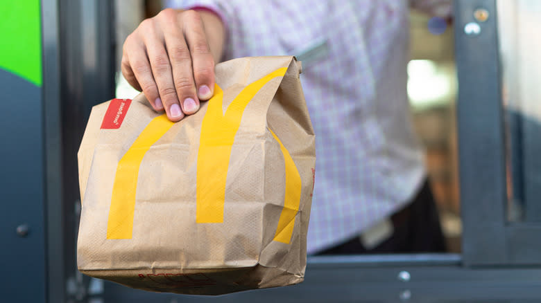 Mcdonalds food bag held by hand
