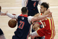 Atlanta Hawks guard Trae Young (11) passes the ball around Washington Wizards center Alex Len (27) during the first half of an NBA basketball game Wednesday, May 12, 2021, in Atlanta. (AP Photo/Butch Dill)