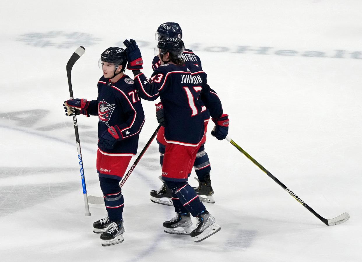 Apr 13, 2022; Columbus, Ohio, USA; Columbus Blue Jackets defenseman Nick Blankenburg (77) gets a pat on the head from Columbus Blue Jackets center Kent Johnson (13) NHL game after Blanketburg's first career point scored between the Columbus Blue Jackets and the Montreal Canadiens at Nationwide Arena. Mandatory Credit: Barbara J. Perenic/Columbus Dispatch