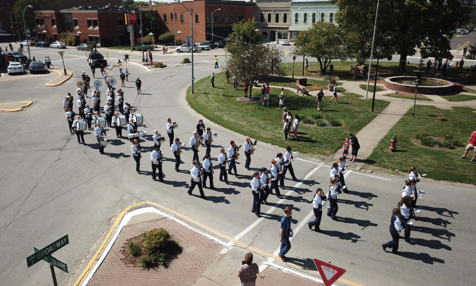A marching band snakes through downtown Monmouth. (City of Monmouth/Facebook)