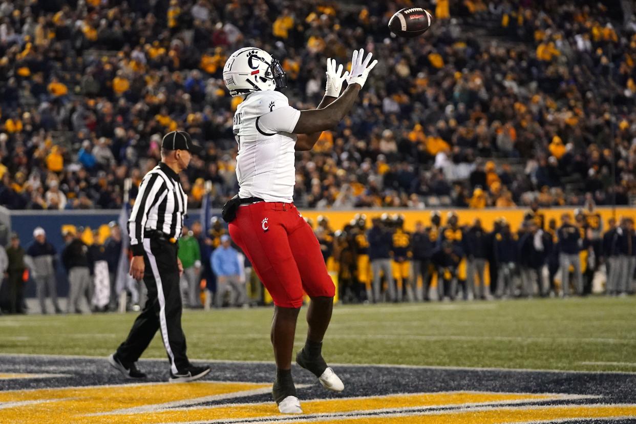 Cincinnati Bearcats tight end Chamon Metayer (7) catches a touchdown in the fourth quarter during UC's 42-21 loss at West Virginia, Saturday, Nov. 18. Metayer has entered the transfer portal.